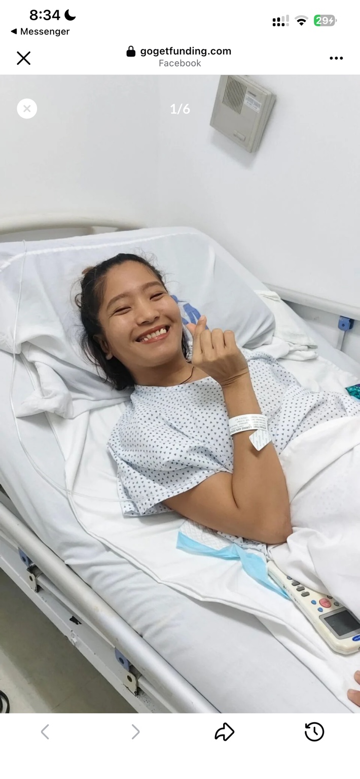 Lorrie smiling from her hospital bed